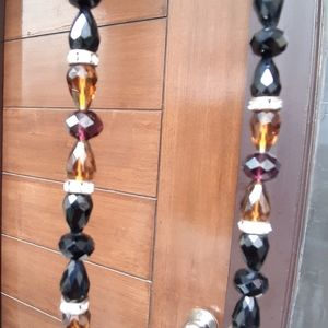 Face mask holding handmade crystal chain.